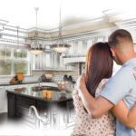Young Military Couple Looking Inside Custom Kitchen and Design Drawing Combination.